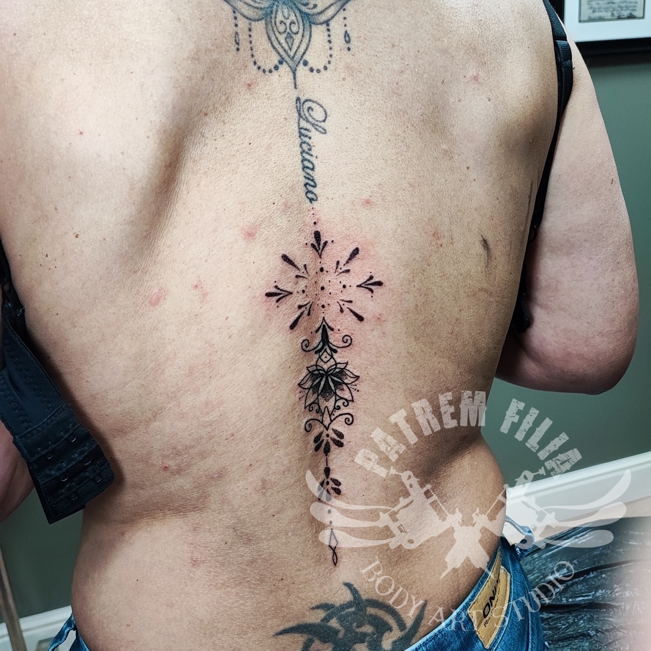 lotus met geometrie op ruggegraat Tattoeages